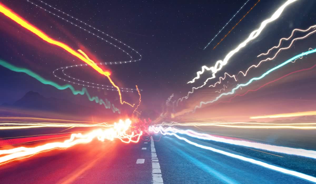 Long exposure image of a car travelling on a road.