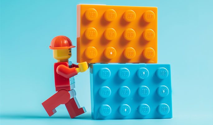 toy man building with lego