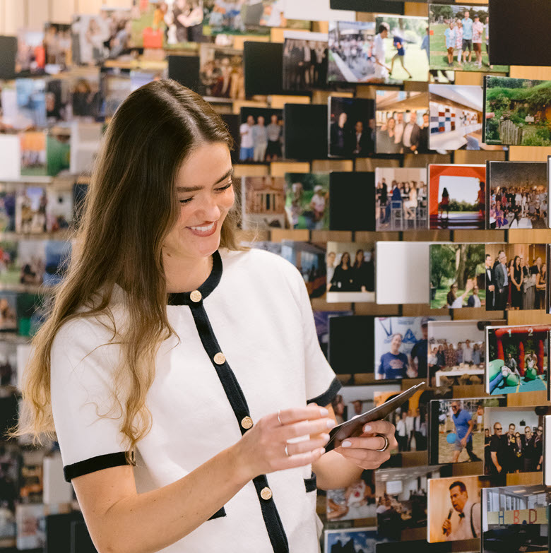 employee and wall of photos